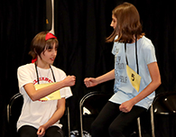 Twins Kate and Olivia Lee support each other during spelling bee